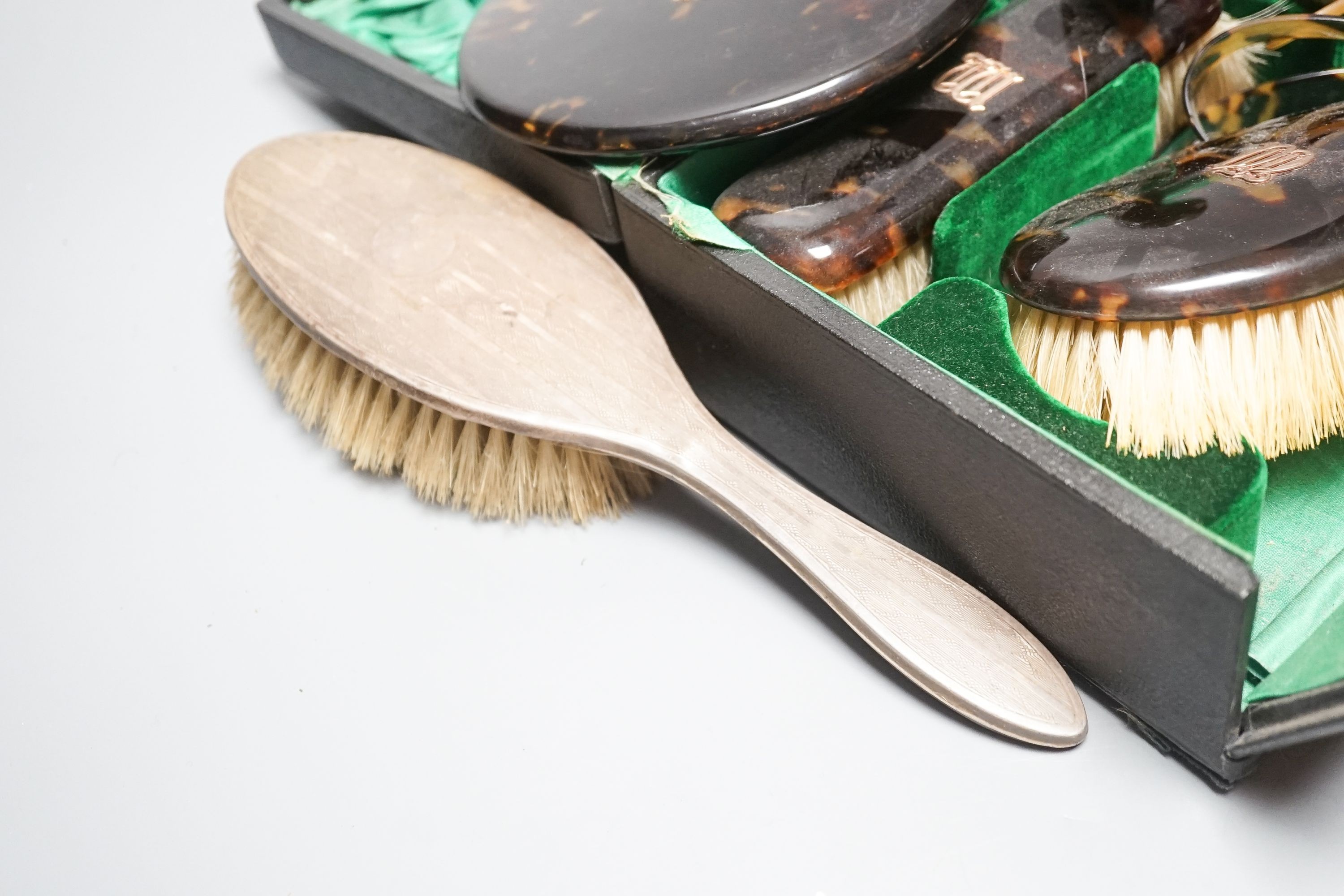 A tortoiseshell toilet set and silver dressing table items